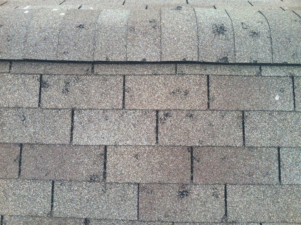 Patterns of grey paving stones with varying textures and lines, possibly on an outdoor surface. average insurance payout for hail damage roof 