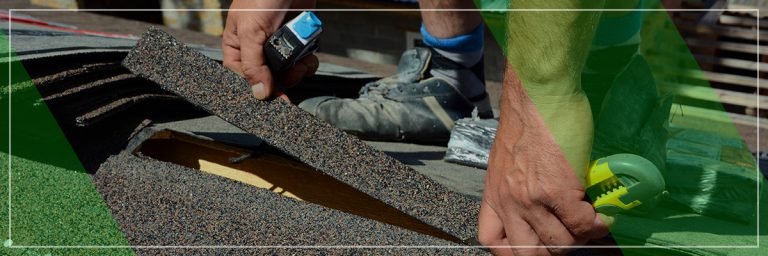A person is installing roofing shingles with a tape measure and utility knife in hand.