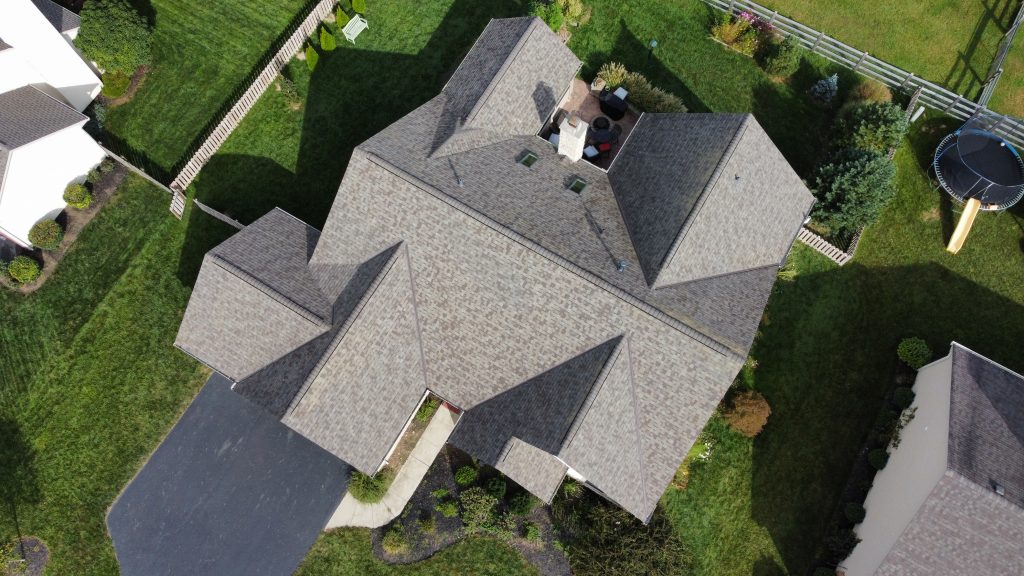 The image showcases a promotional ad for winter roofing estimates with a visible snow-covered roof in Dublin, Ohio.