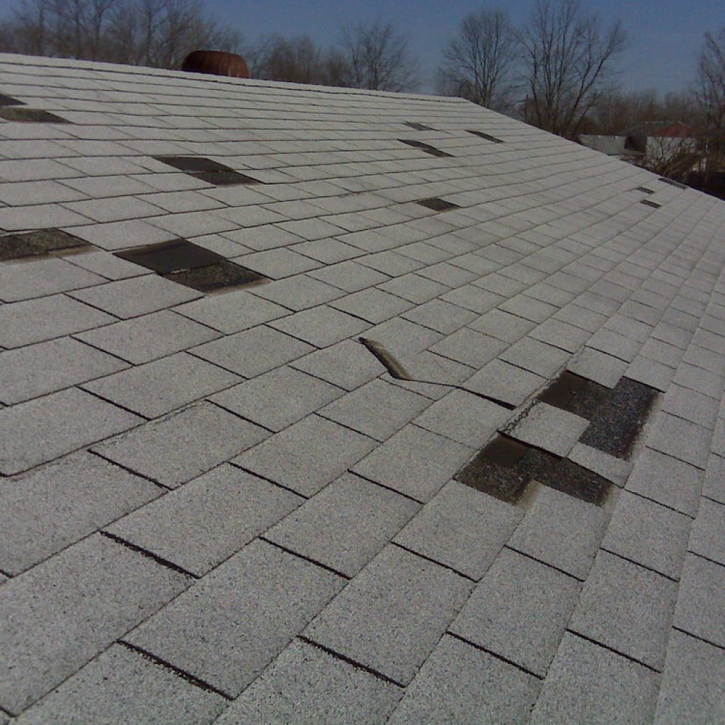 damaged roof with missing shingles - hail damage roofing companies