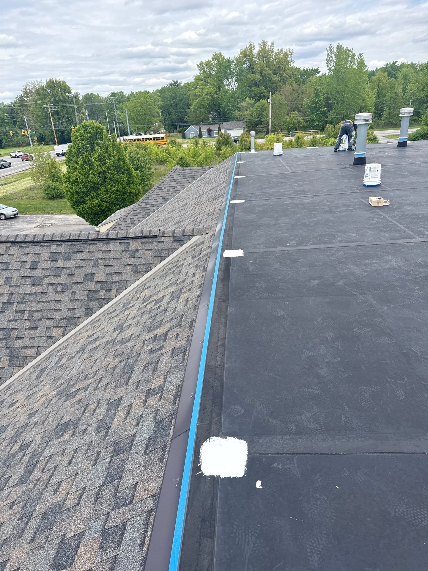 Applying white silicone coating to a flat roof