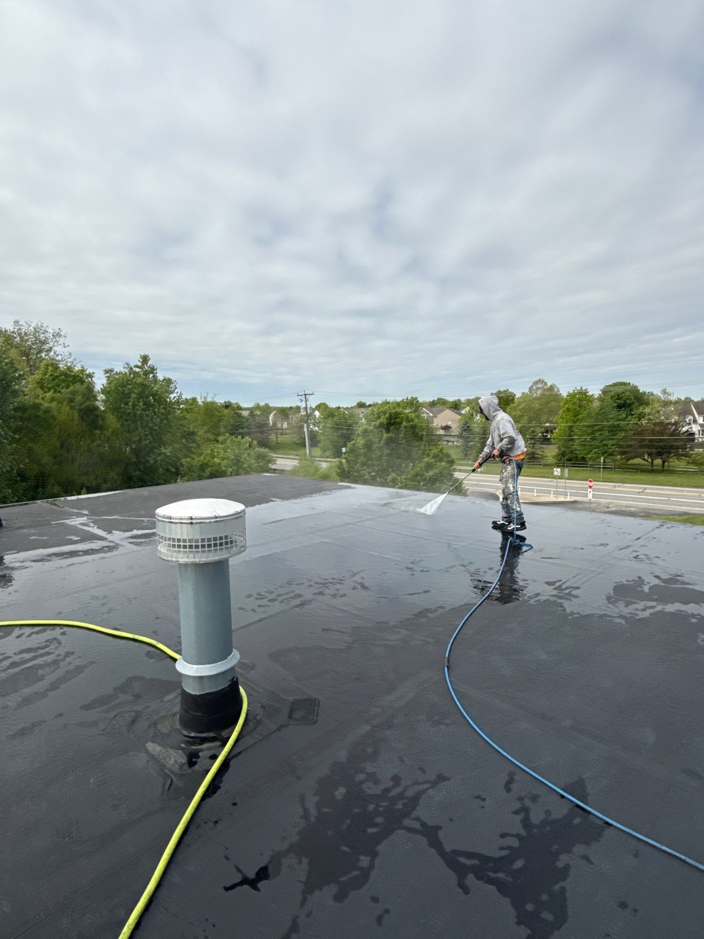 Power washing a commercial roof