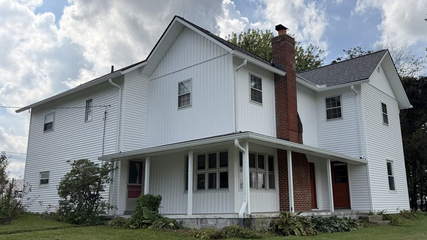 After: white CertainTeed Restoration Classic vinyl siding with new soffits and fascia